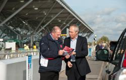 Jim Betchley (left) welcomes his first customer to I Love meet and greet at Stansted